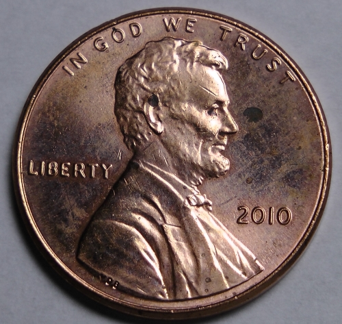 Side-by-side comparison of normal 2010 penny (left) versus doubled die obverse variety (right) showing doubling on LIBERTY