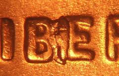 2010 penny BIE die crack error showing raised line between B and E in LIBERTY resembling a letter I